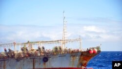 FILE - The Chinese squid fishing vessel Fu Yuan Yu 7880 sails on the Pacific Ocean on July 18, 2021. The Pingtan-affiliated vessel was arrested by South Africa in 2016 after it tried to flee a naval patrol that suspected it of illegal squid fishing. 