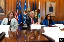 Attorney General Merrick Garland, center, announces a team to conduct a critical incident review of the shooting in Uvalde, Texas, during a media availability at the Department of Justice, June 8, 2022.