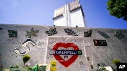 Flowers and tributes left outside the remains of the Grenfell Tower, in London, June 14, 2022. Tuesday marks the fifth anniversary of the fire that killed 72 people.