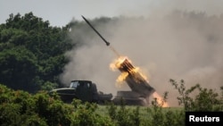 FILE - Ukrainian service members fire a multiple rocket launch system, near the town of Lysychansk, Luhansk region, amid Russia's attack on Ukraine, June 12, 2022. 