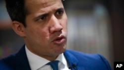 FILE - Venezuela's Juan Guaido speaks during an interview with The Associated Press, in Caracas, Dec. 9, 2020.