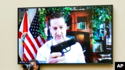 Rep. Greg Steube, R-Fla., holds up his own handgun as he speaks via videoconference as the House Judiciary Committee meets to advance a series of Democratic gun control measures, called the Protecting Our Kids Act, June 2, 2022.