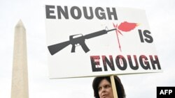 A gun control advocate participates in the "March for Our Lives" rally against gun violence, near the Washington Monument on the National Mall in Washington, June 11, 2022.