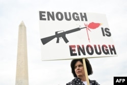 FILE - A gun control advocate participates in the "March for Our Lives" rally against gun violence, near the Washington Monument on the National Mall in Washington, June 11, 2022.