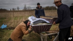 Надя Трубчанинова над гробом сына Вадима, убитого 30 марта российскими солдатами в Буче