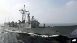 FILE - A Perry-class frigate from the Taiwanese navy runs through exercises off Kaohsiung, Taiwan.