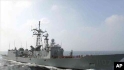 FILE - A Perry-class frigate from the Taiwanese navy runs through exercises off Kaohsiung, Taiwan.