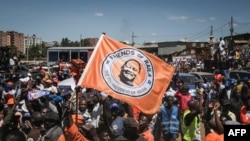 FILE: Supporter holds a flag of Azimio la Umoja (Aspiration to Unite) coalition party's Raila Odinga after being officially nominated as Presidential candidates by Independent Electoral and Boundaries Commission (IEBC) at Kibera slum in Nairobi, Kenya, on 6.5.2022