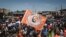 FILE: Supporter holds a flag of Azimio la Umoja (Aspiration to Unite) coalition party's Raila Odinga after being officially nominated as Presidential candidates by Independent Electoral and Boundaries Commission (IEBC) at Kibera slum in Nairobi, Kenya, on 6.5.2022