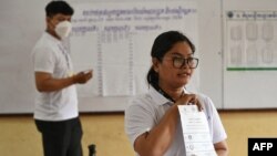 Cambodian election officials count ballots at a polling station during local commune elections in Phnom Penh, June 5, 2022. 