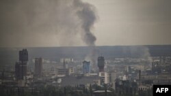 Smoke rises from the city of Sievierodonetsk in the eastern Ukrainian Donbas region, June 13, 2022. 