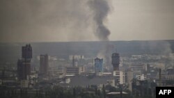 Smoke rises from the city of Sievierodonetsk in the eastern Ukrainian region of Donbas on June 13, 2022. 