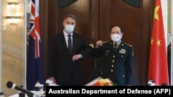 This handout photo taken and released on June 12, 2022 Australia's Defense Minister Richard Marles (L) meeting with China's Defense Minister Wei Fenghe on the sidelines of the Shangri-La Dialogue summit in Singapore.