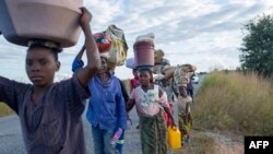 Displaced families from the community of Impire, a town in the district of Metuge in the Cabo Delgado province, flee armed insurgents on June 14, 2022.