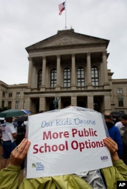 In this June 23, 2011 photo, about 200 charter school supporters attend a rally on the Capitol steps in Atlanta. (AP Photo/John Bazemore)