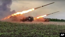 In this handout photo released by the Russian Defense Ministry Press Service June 1, 2022, the Russian military's Uragan multiple rocket launchers fire missiles at Ukrainian troops at an unspecified location.