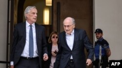 Former FIFA president Sepp Blatter (C), next to his lawyer Lorenz Erni, leaves Switzerland's Federal Criminal Court after the first day of his trial over a suspected fraudulent payment, in Bellinzona, Switzerland, June 8, 2022. 