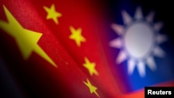 Chinese and Taiwanese printed flags are seen in this photo illustration.