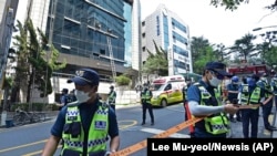 Des policiers établissent un cordon de sécurité sur les lieux d'un incendie à Daegu, en Corée du Sud, le jeudi 9 juin 2022. 