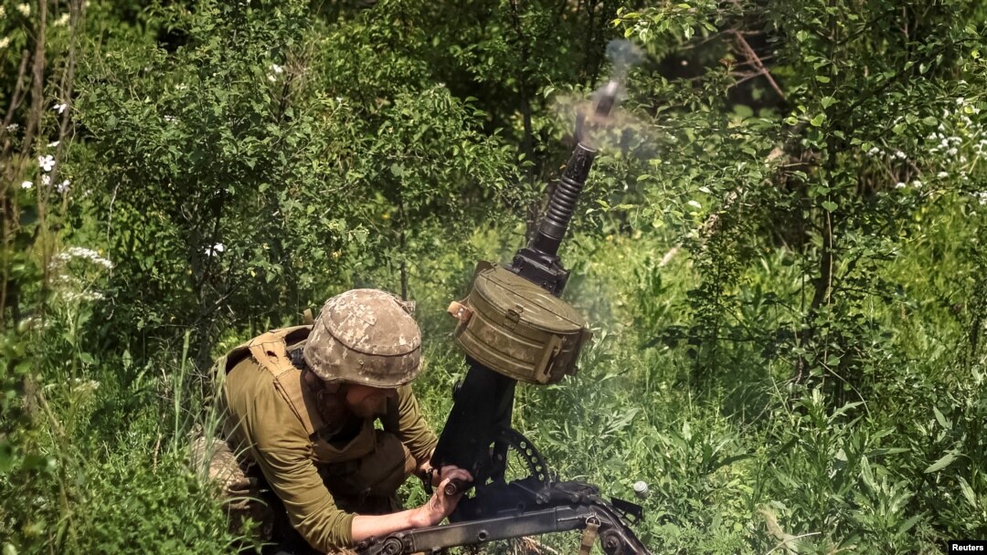 A Ukrainian service member shoots from an automatic grenade launcher at a position on the front line, amid Russia's attack on Ukraine, near Bakhmut, Donbas region, Ukraine, June 5, 2022. 