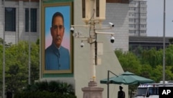 A paramilitary police officer stands guard near a portrait of Sun Yat-sen, who is widely regarded as the founding father of modern China, on Tiananmen Square on April 28, 2022, in Beijing.