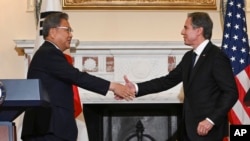 Secretary of State, Antony Blinken shakes hands with South Korean Foreign Minister Park Jin at the State Department in Washington, June 13, 2022, after a news conference. 