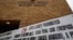 FILE - Signs prohibiting guns are displayed outside the Uvalde Consolidated Independent School District board room, where officials gave an update in the wake of the shooting at Robb Elementary, June 9, 2022, in Uvalde, Texas. 