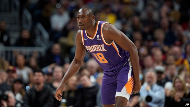 Phoenix Suns center Bismack Biyombo readies for action against the Denver Nuggets in Denver, Colorado, March 24, 24, 2022.