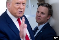 Campaign manager Bill Stepien stands alongside US President Donald Trump as he speaks with reporters aboard Air Force One on Aug. 28, 2020.