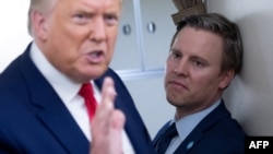 Campaign manager Bill Stepien stands alongside US President Donald Trump as he speaks with reporters aboard Air Force One on Aug. 28, 2020.