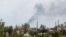ইউক্রেন-রাশিয়া সংঘাতে ইউক্রেনের লুহানস্ক অঞ্চলের রুবিঝনে শহরের এক গির্জা এবং আবাসিক ভবন থেকে ধোঁয়া উঠতে দেখা যাচ্ছে, ১ জুন ২০২২।