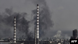 Smoke and dirt rise from the city of Sievierodonetsk during fighting between Ukrainian and Russian troops at the eastern Ukrainian region of Donbas on June 14, 2022. 