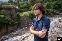 Boyan Slat, the creator of The Ocean Cleanup project, stands along the Las Vacas river in Chinautla, near Guatemala City, Wednesday, June 8, 2022. (AP Photo/Moises Castillo)