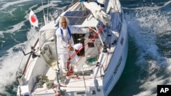 Japan's Kenichi Horie on his sailboat after completing his solo transpacific voyage, June 4, 2022, in Osaka Bay, western Japan. 