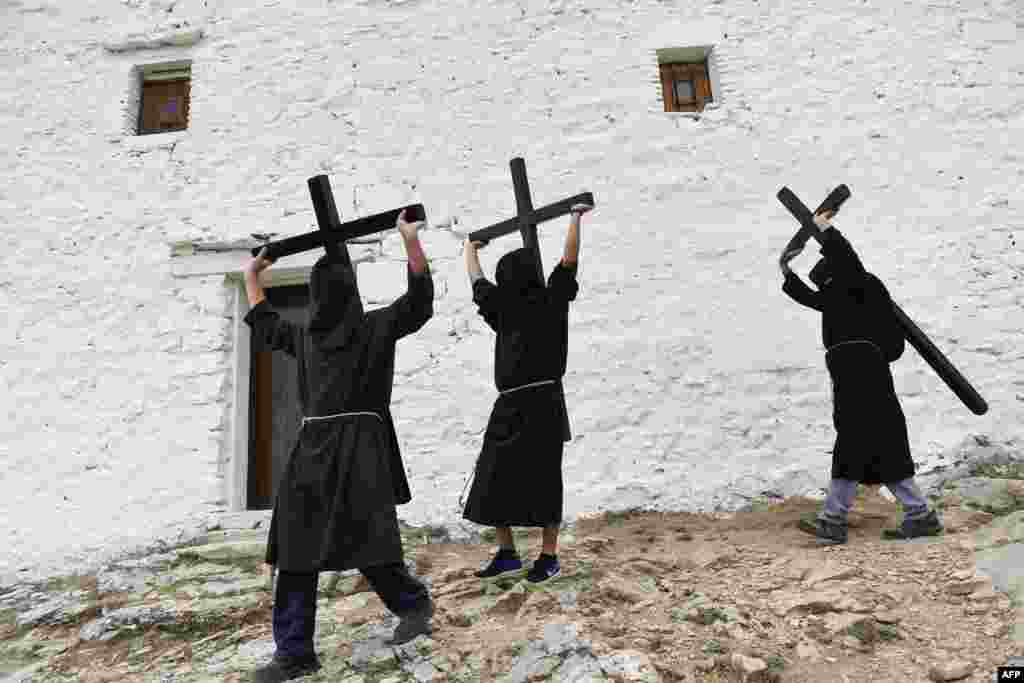 Penitents carry crosses during the &quot;Romeria a la Trinidad&quot; pilgrimage in the village of Lumbier, Spain,.