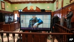 FILE - Russian opposition leader Alexey Navalny appears on a video link from prison provided by the Russian Federal Penitentiary Service at Moscow City Court, May 24, 2022.