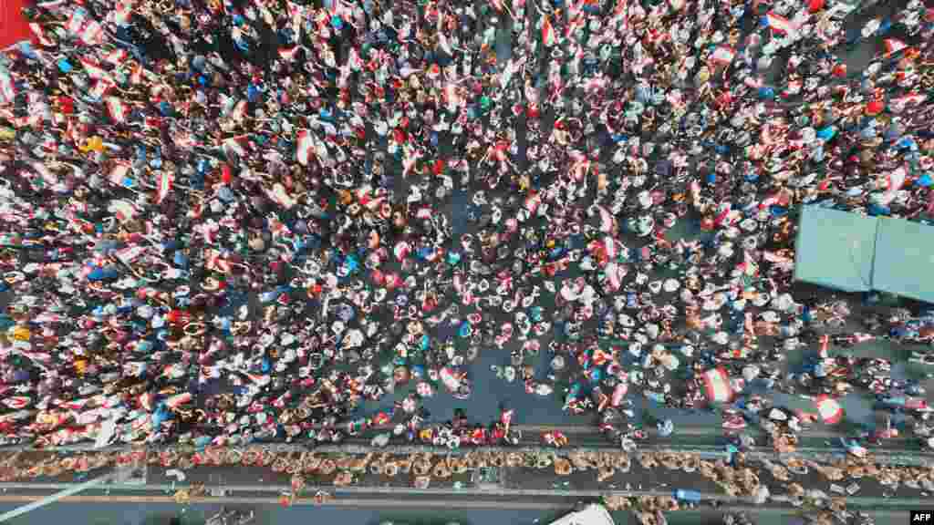 An aerial view shows Lebanese protesters gathering along the side of the Beirut-Jounieh highway in the northern Beirut suburb of Jal el-Dib on the seventh day of protest against tax increases and official corruption.