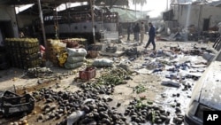 Residents and Iraqi soldiers inspect the site of a bomb attack in Khalis, northeast of Baghdad, December 1, 2011