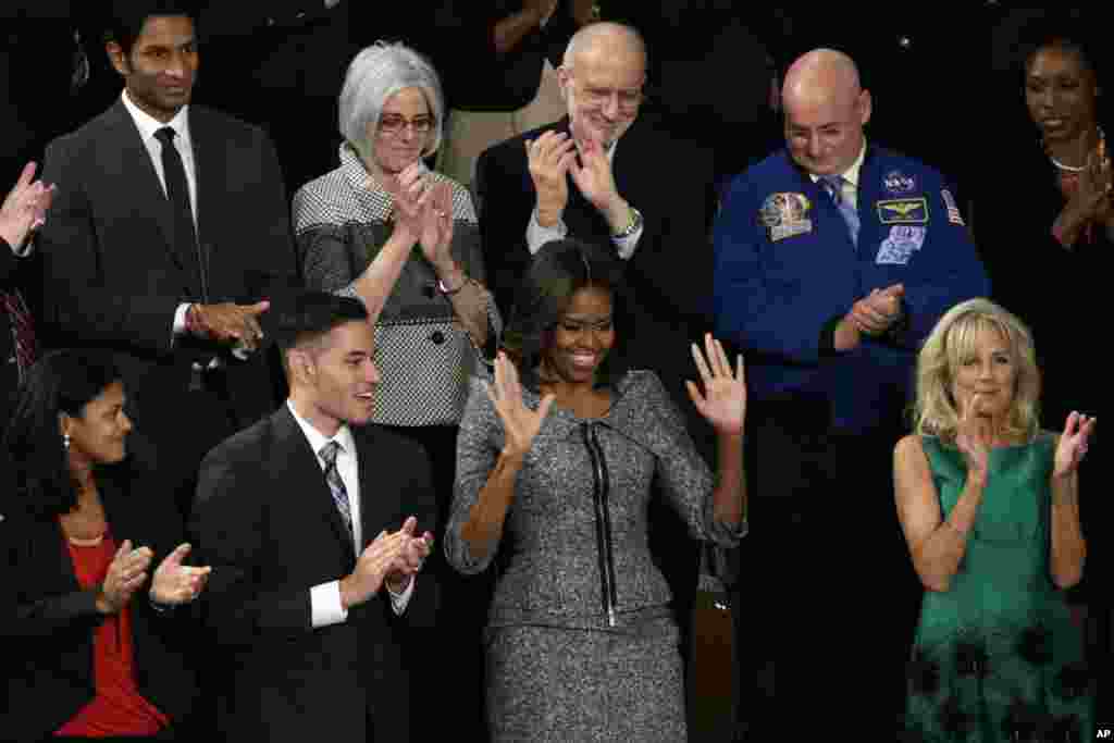 First lady Michelle Obama acknowledges applause before President Barack Obama's State of the Union address on Capitol Hill, Jan. 20, 2015.