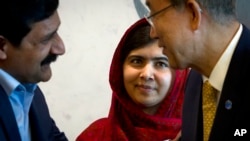 Pakistani schoolgirl activist Malala Yousafzai observes as her father, Ziauddin Yousafzai, meets U.N. Secretary General Ban Ki-moon at U.N. headquarters Aug. 18, 2014.