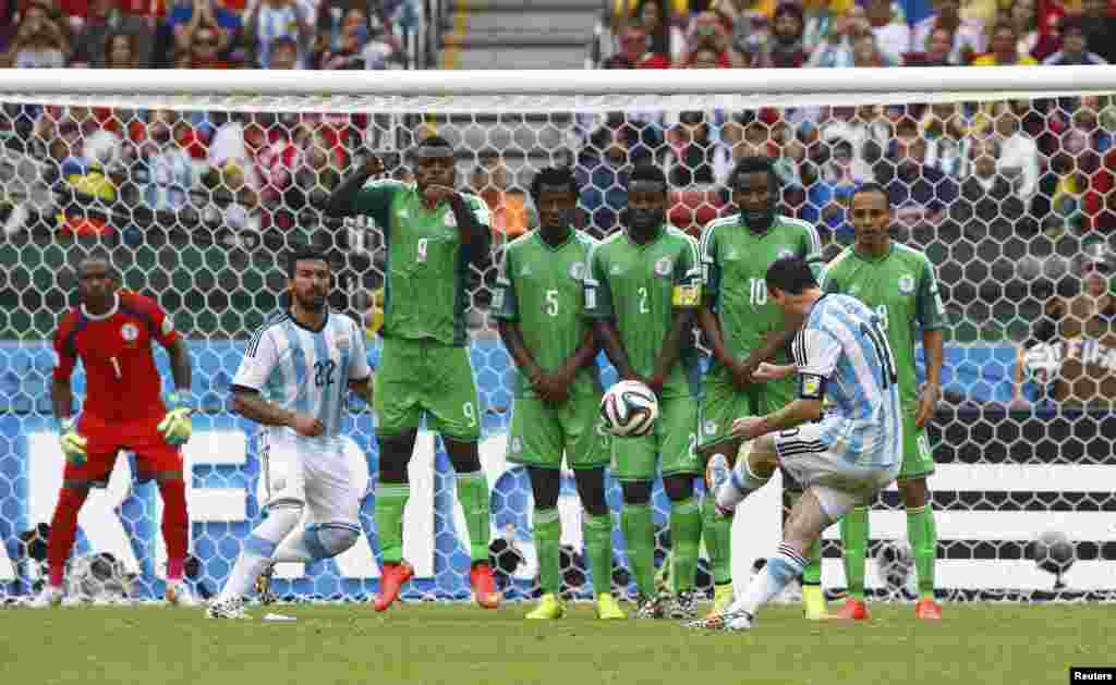 Argentinian Lionel Messi scores on a free kick against Nigeria at the Beira Rio stadium, Porto Alegre, June 25, 2014. 