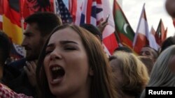 A women shouts as people protest against Kosovo President Hashim Thaci's border change proposal deal with Serbia in Pristina, Kosovo, Sept. 29, 2018.