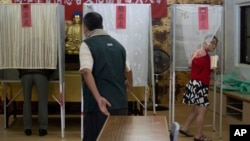FILE - Taiwan residents cast their votes at a polling station in southern Taiwan's Kaoshiung city, Jan. 11, 2020.