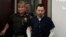 FILE - Dr. Larry Nassar is escorted into court during the seventh day of his sentencing hearing Wednesday, Jan. 24, 2018, in Lansing, Mich. Nassar has admitted sexually assaulting athletes when he was employed by Michigan State University and USA Gymnastics.
