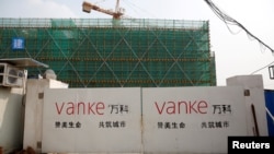 上海一处建筑工地的大门上万科的标志。（资料照片）