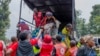 People who crossed from Congo disembark a truck in Gyseny, Rwanda, Jan. 28, 2025, following M23 rebels' advances into eastern Congo's capital Goma.