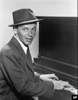 In this 1957 photo, singer Frank Sinatra plays the piano. (File Photo)