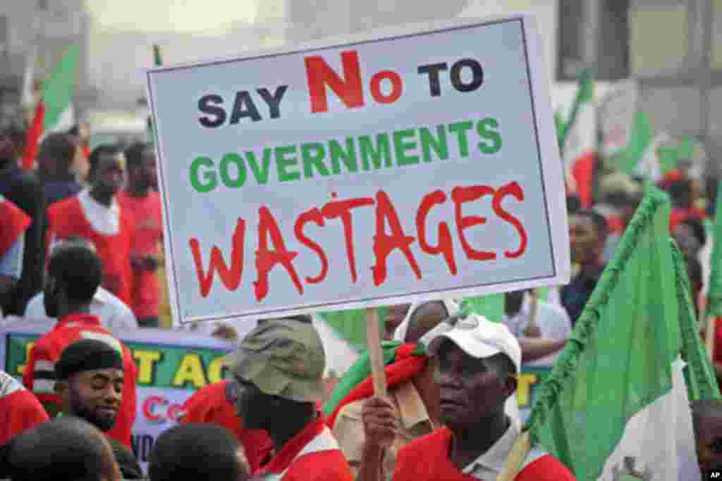 A protester holds a banner during a demonstration against a fuel subsidy removal in Lagos, Nigeria, January 9, 2012.