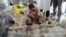 Shuna Miya cries over bodies of his daughters, before their bodies are taken for the funeral just behind Inani Beach near Cox's Bazar, Bangladesh, Sept. 29, 2017. 