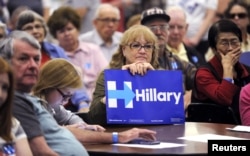 Hillary Clinton supporter Shirley Boggs holds a sign during the Democratic presidential candidate caucus at Emporia High School in Emporia, Kansas, March 5, 2016.